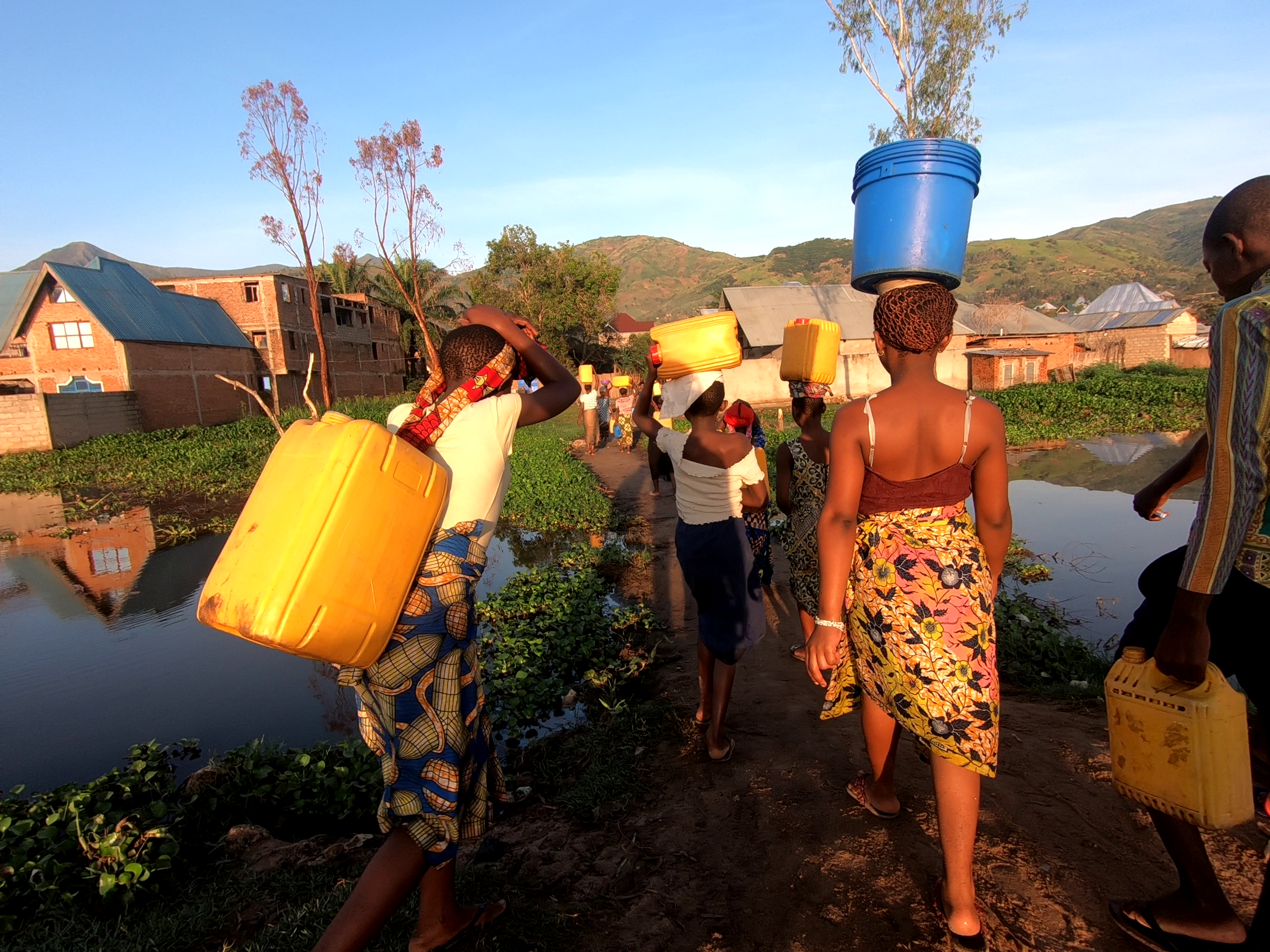 Congolese community members gathering water.