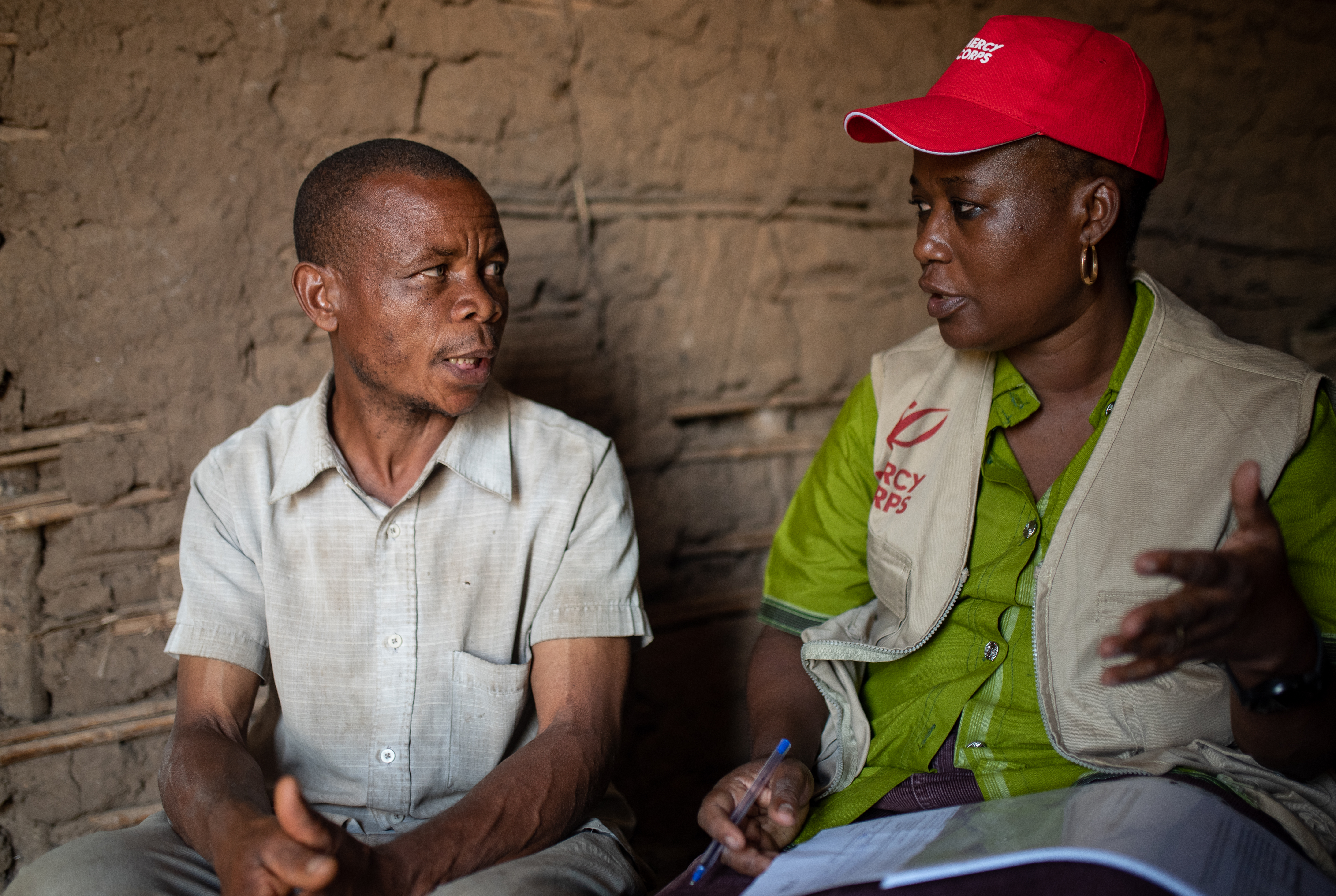 Mercy Corps employee speaks with community member.