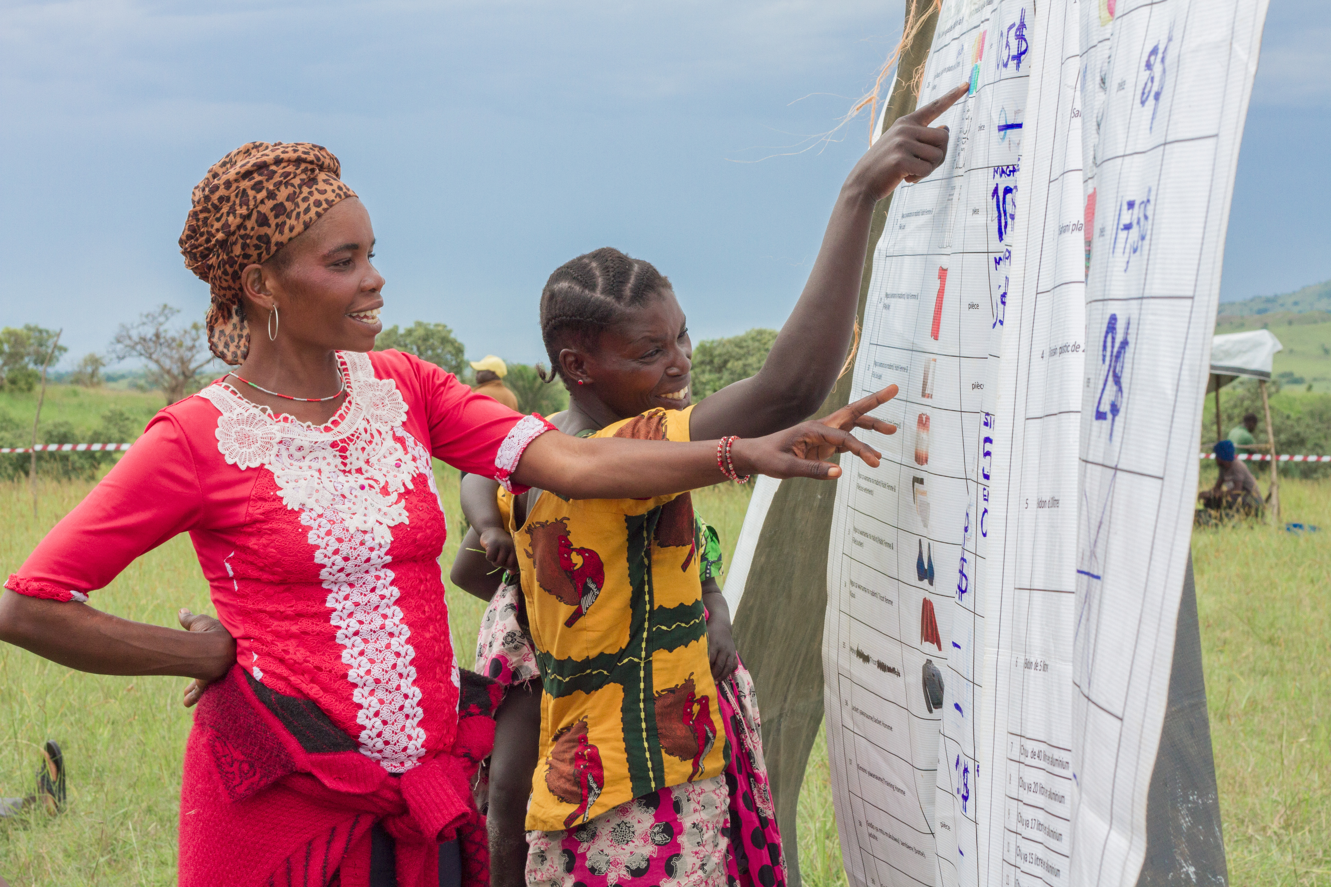 Two community members reviewing a spreadsheet. 