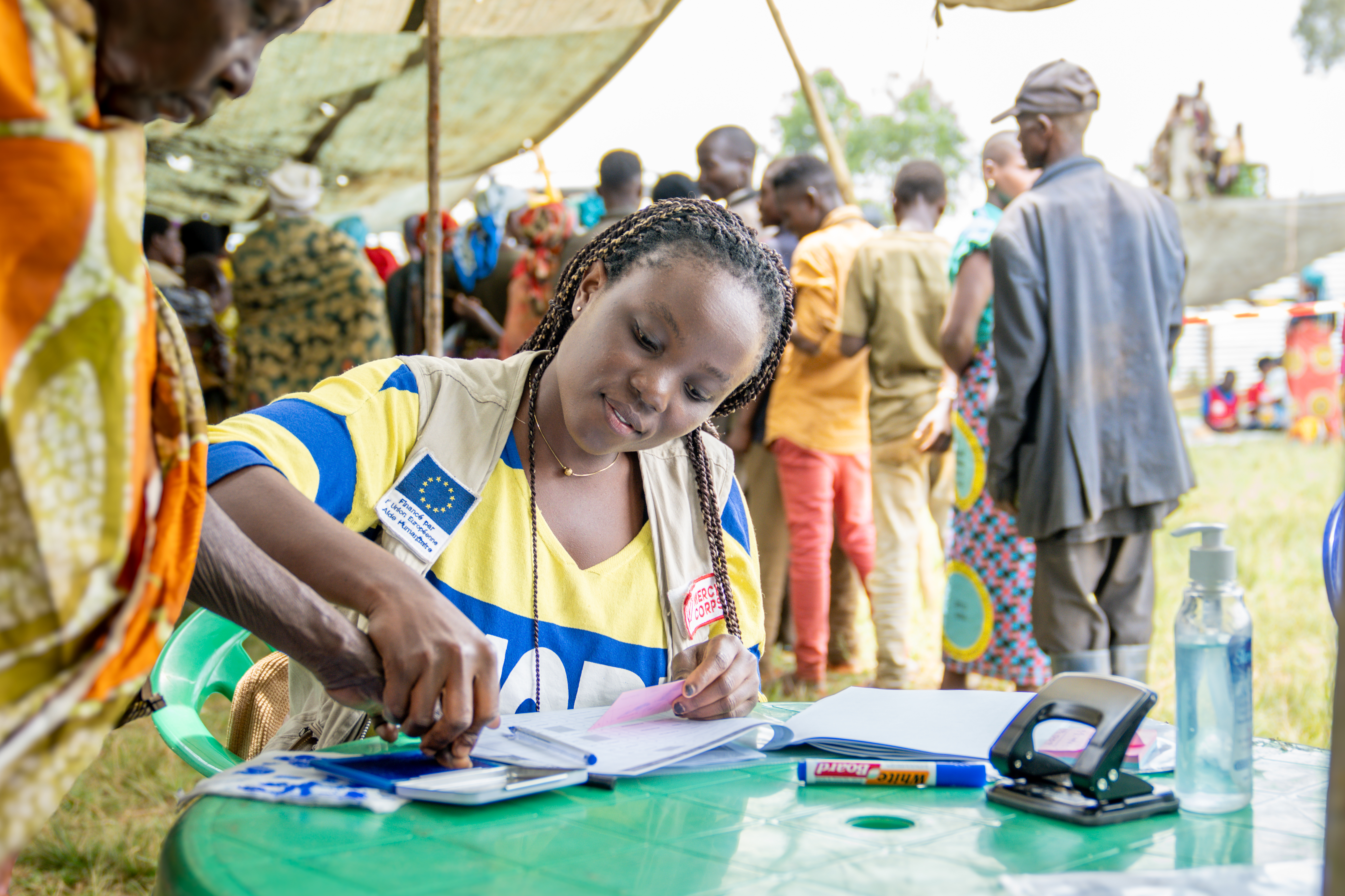 A person taking the fingerprints of another adult.