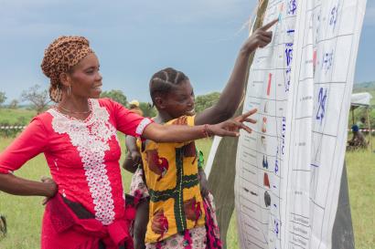 Two community members reviewing a spreadsheet.