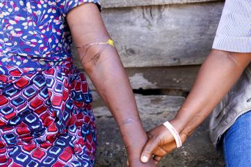 Drc individuals holding hands.