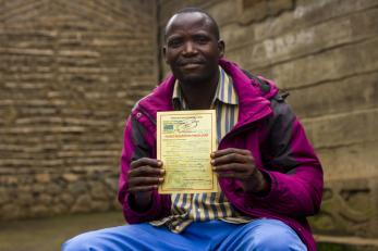 Congolese farmer with his land title.