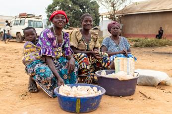 Congolese women selling cassava chips on a roadside. 