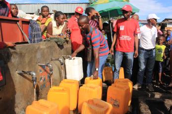 People get water from a tap in DR Congo