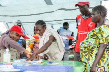 People working in an aid tent in DRC
