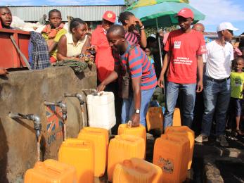 People get water from a tap in dr congo