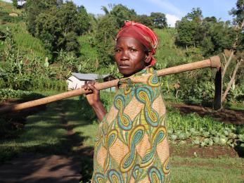 Congolese farmer in front of her crops.
