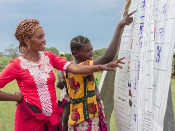 Two community members reviewing a spreadsheet. 