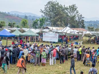 A large group of people at an outdoor distribution event.
